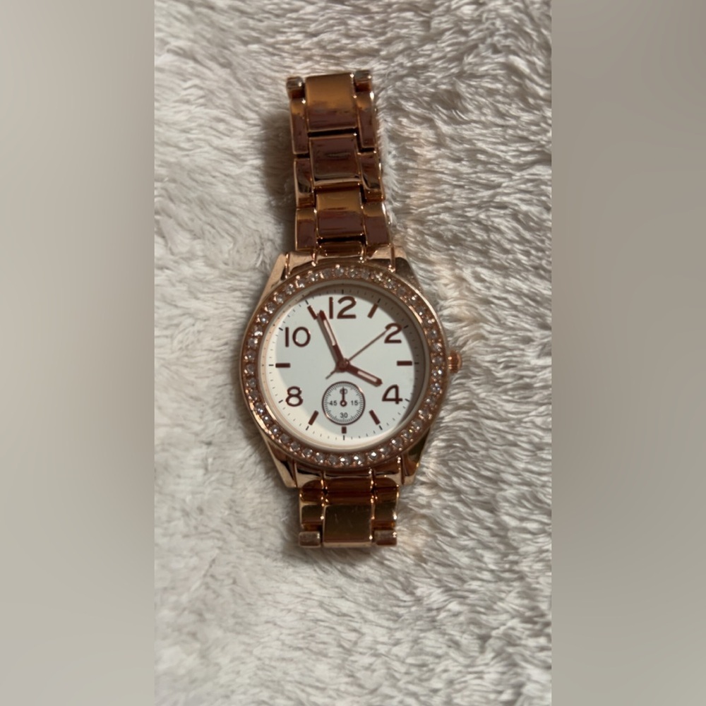 Claire's watch with a rose gold-tone bracelet and a crystal-accented bezel